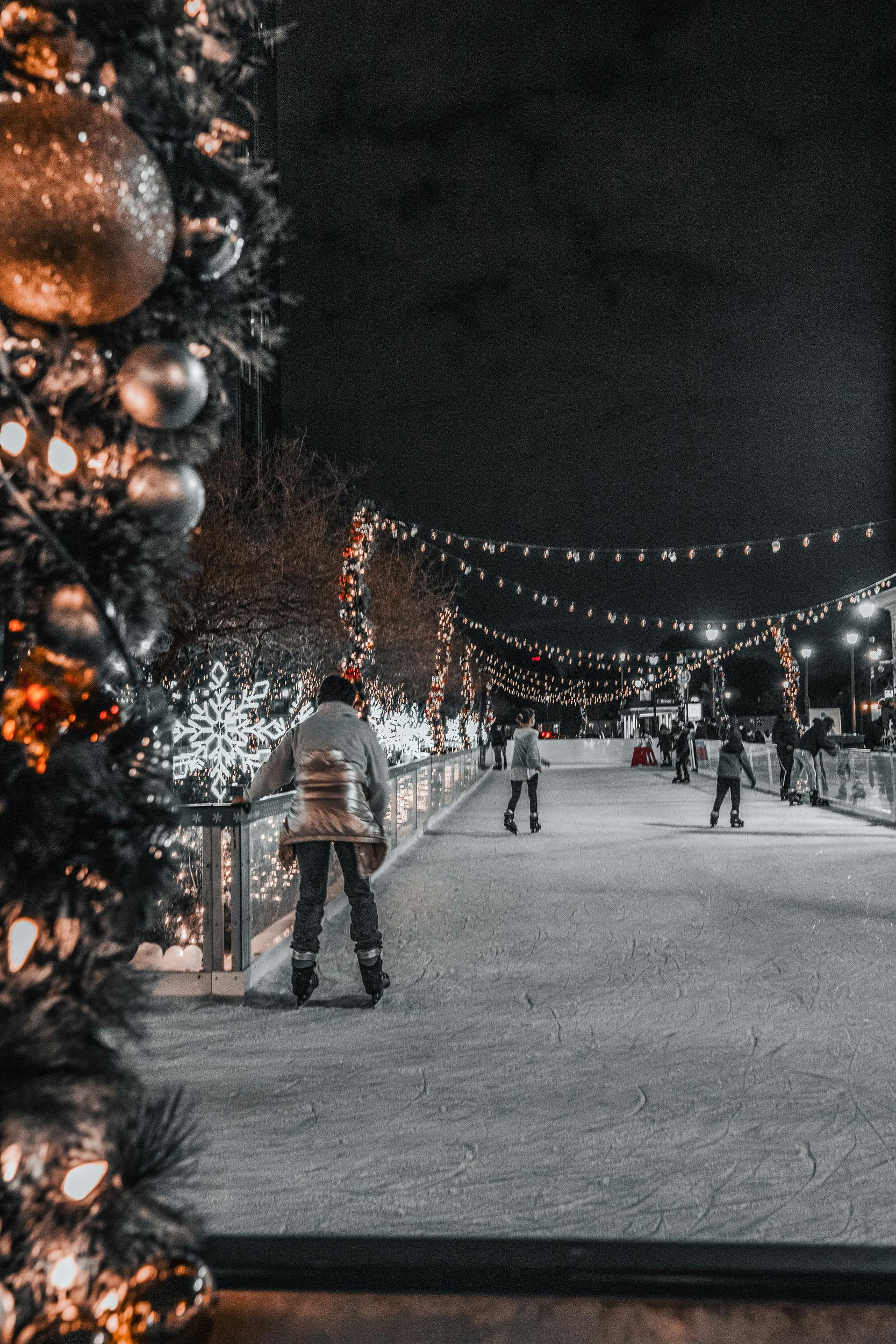 People Ice Skating During Night Time